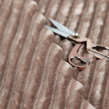 A warm, taupe-coloured textile featuring a repeating, vertical channel-tufted pattern that alternates between soft, high-pile bands and narrow, flat lines.