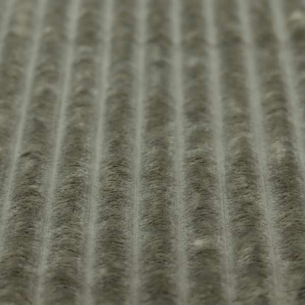 A muted, olive green textile featuring a repeating, vertical channel-tufted pattern that alternates between soft, high-pile bands and narrow, flat lines.