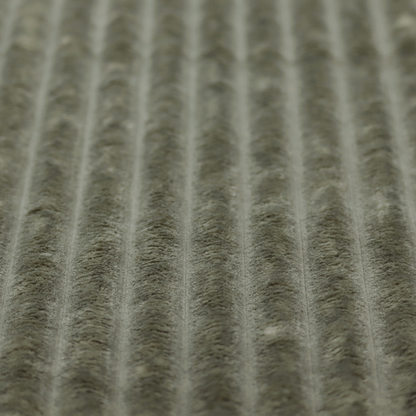 A muted, olive green textile featuring a repeating, vertical channel-tufted pattern that alternates between soft, high-pile bands and narrow, flat lines.