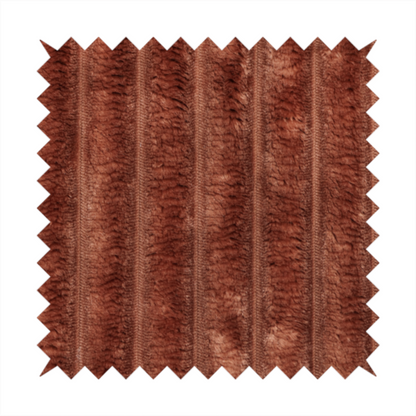 A orange rust, vertically ribbed, channel-tufted plush fabric with a soft, fuzzy texture.