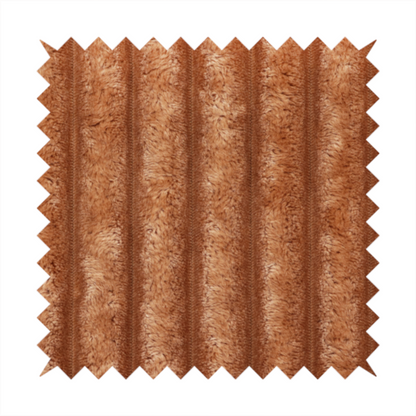 A tanned copper, vertically ribbed, channel-tufted plush fabric.