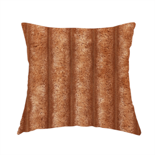 The fabric used to create this handmade cushion is a tanned copper, vertically ribbed, channel-tufted plush fabric.