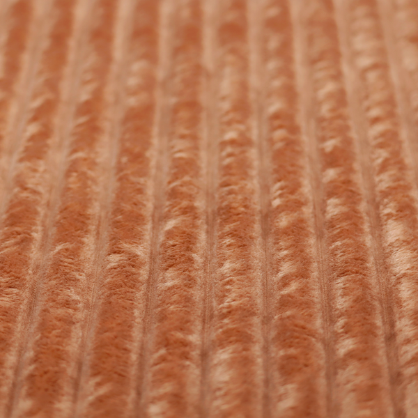 A tanned copper, vertically ribbed, channel-tufted plush fabric.