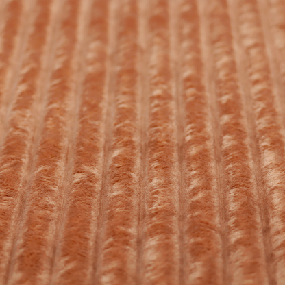A tanned copper, vertically ribbed, channel-tufted plush fabric.