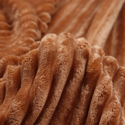 A tanned copper, vertically ribbed, channel-tufted plush fabric.