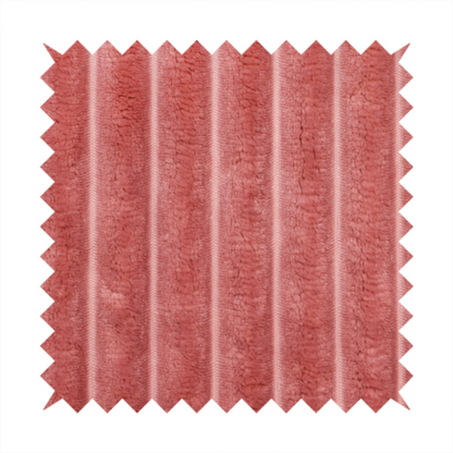 A pink, vertically ribbed, channel-tufted plush fabric.
