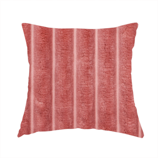 The fabric used to create this handmade cushion is a pink, vertically ribbed, channel-tufted plush fabric.