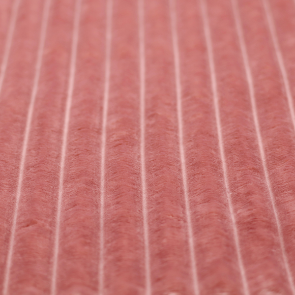 A pink, vertically ribbed, channel-tufted plush fabric.
