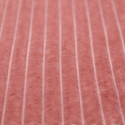 A pink, vertically ribbed, channel-tufted plush fabric.