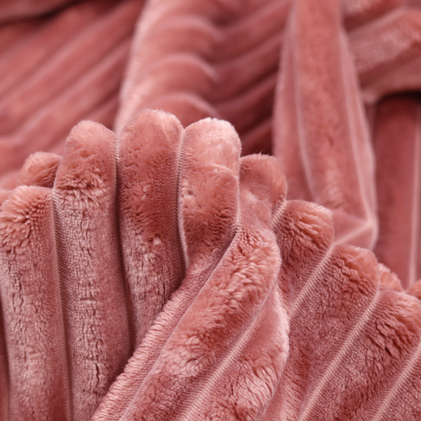 A pink, vertically ribbed, channel-tufted plush fabric.