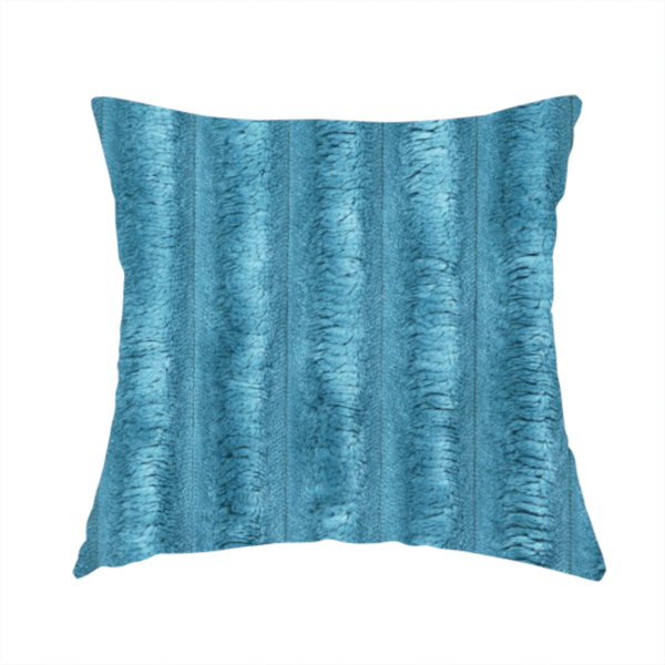The fabric used to create this handmade cushion is a saturated, cool-toned teal or turquoise blue.