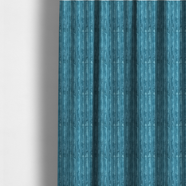 The fabric used to create these made-to-measure curtains is a saturated, cool-toned teal or turquoise blue.