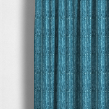 The fabric used to create these made-to-measure curtains is a saturated, cool-toned teal or turquoise blue.