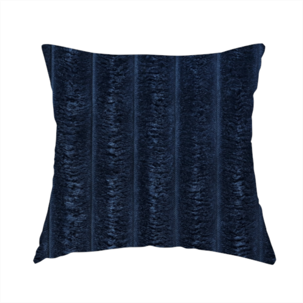 The fabric used to create this handmade cushion is a navy blue, vertically ribbed plush fabric.