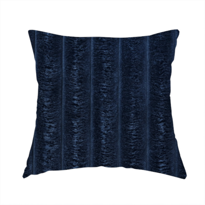 The fabric used to create this handmade cushion is a navy blue, vertically ribbed plush fabric.