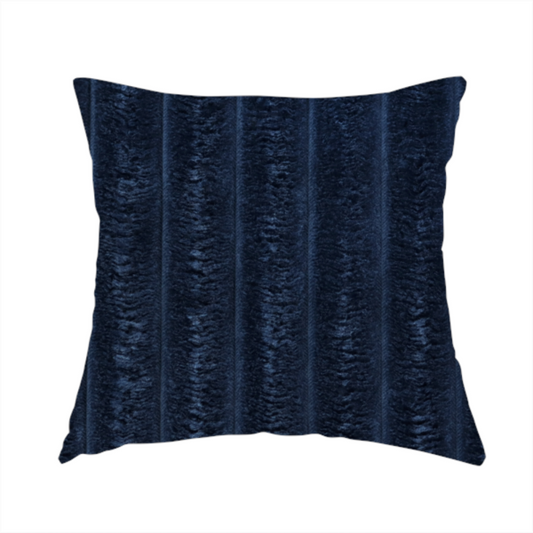 The fabric used to create this handmade cushion is a navy blue, vertically ribbed plush fabric.