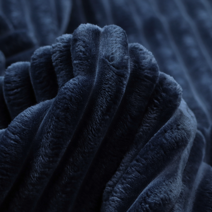 A navy blue, vertically ribbed plush fabric.