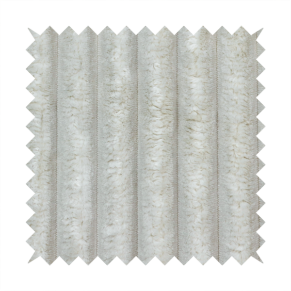 A light grey, vertically ribbed, channel-tufted plush fabric.