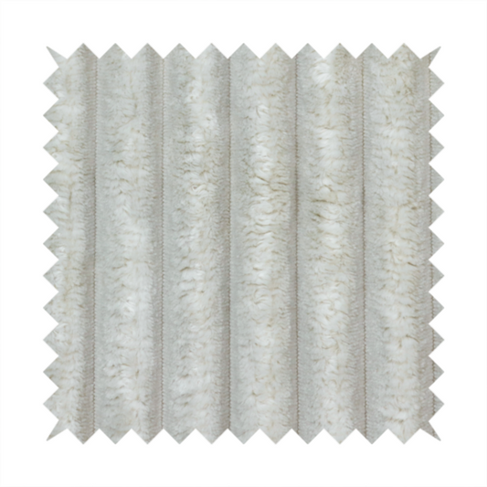 A light grey, vertically ribbed, channel-tufted plush fabric.