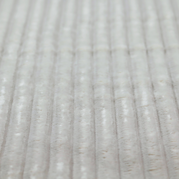 A light grey, vertically ribbed, channel-tufted plush fabric.