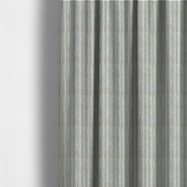 The fabric used to create these made-to-measure curtains is a light grey, vertically ribbed, channel-tufted plush fabric.