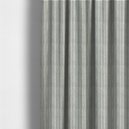 The fabric used to create these made-to-measure curtains is a light grey, vertically ribbed, channel-tufted plush fabric.