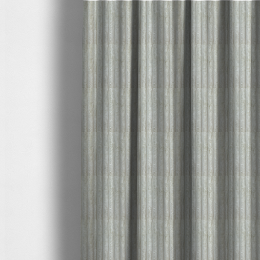 The fabric used to create these made-to-measure curtains is a light grey, vertically ribbed, channel-tufted plush fabric.