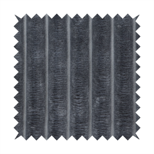 A charcoal grey, vertically ribbed, channel-tufted plush fabric.