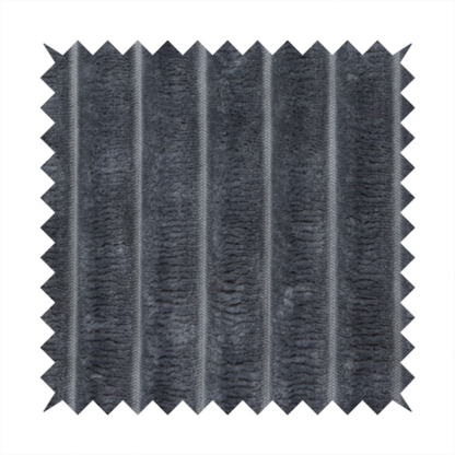 A charcoal grey, vertically ribbed, channel-tufted plush fabric.