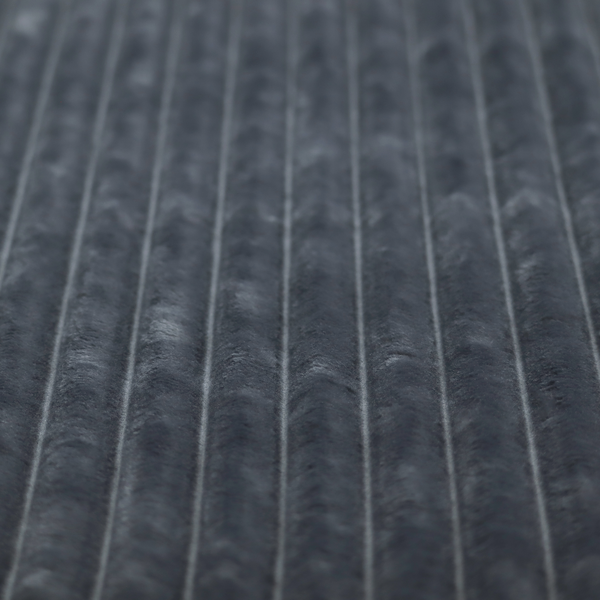 A charcoal grey, vertically ribbed, channel-tufted plush fabric.