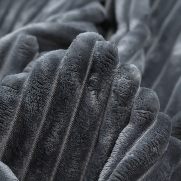A charcoal grey, vertically ribbed, channel-tufted plush fabric.