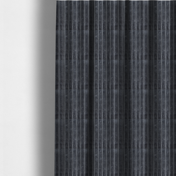 The fabric used to create these made-to-measure curtains is a charcoal grey, vertically ribbed, channel-tufted plush fabric.