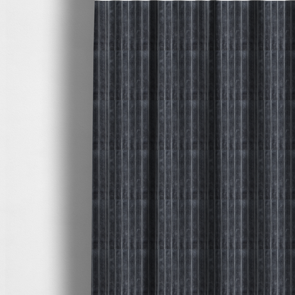 The fabric used to create these made-to-measure curtains is a charcoal grey, vertically ribbed, channel-tufted plush fabric.