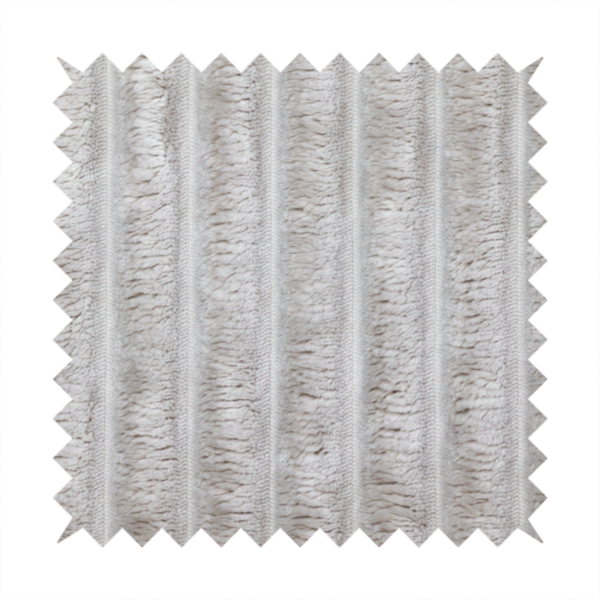 A silver vertically ribbed, channel-tufted plush fabric.