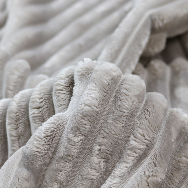 A silver vertically ribbed, channel-tufted plush fabric.