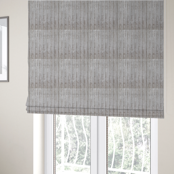 The fabric used to create these Roman blinds is a silver vertically ribbed, channel-tufted plush fabric.
