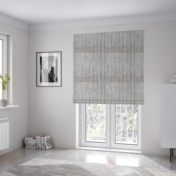 The fabric used to create these Roman blinds is a silver vertically ribbed, channel-tufted plush fabric.