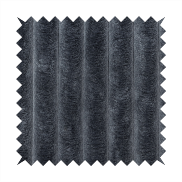 A charcoal grey, vertically ribbed, channel-tufted plush fabric.