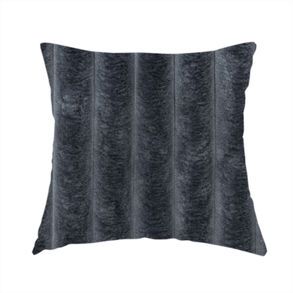 The fabric used to create this handmade cushion is a charcoal grey, vertically ribbed, channel-tufted plush fabric.
