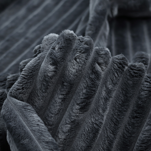 A charcoal grey, vertically ribbed, channel-tufted plush fabric.