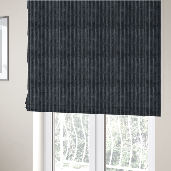 The fabric used to create these Roman blinds is a charcoal grey, vertically ribbed, channel-tufted plush fabric.