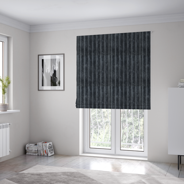 The fabric used to create these Roman blinds is a charcoal grey, vertically ribbed, channel-tufted plush fabric.