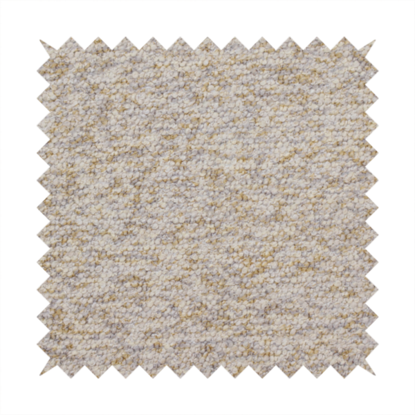 A cream, light grey, and subtle mustard yellow textured upholstery fabric.