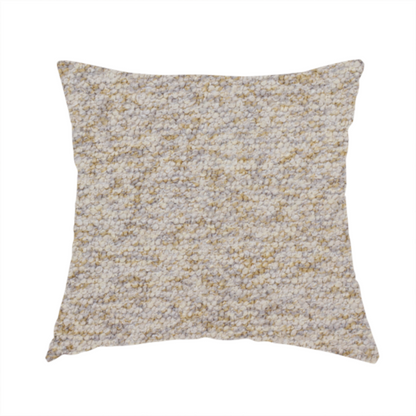 The fabric used to create these handmade cushions is a cream, light grey, and subtle mustard yellow textured upholstery fabric.