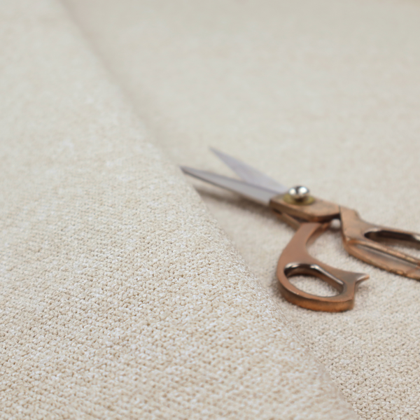 A creamy off-white textured upholstery fabric with a consistent, neutral weave.