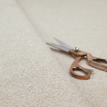 A creamy off-white textured upholstery fabric with a consistent, neutral weave.