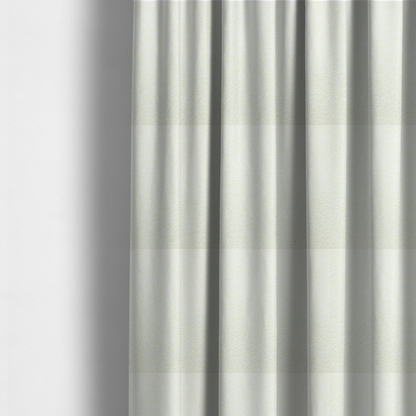 The fabric used to create these made-to-measure curtains is a bright off-white textured upholstery fabric with a clean, light weave.