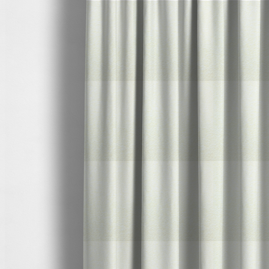 The fabric used to create these made-to-measure curtains is a bright off-white textured upholstery fabric with a clean, light weave.