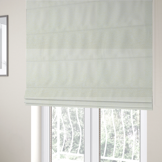 The fabric used to create these Roman blinds is a bright off-white textured upholstery fabric with a clean, light weave.