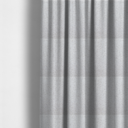 The fabric used to create these made-to-measure curtains is a light cool-toned grey and white blend textured upholstery fabric.
